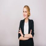 Joyful confident blonde businesswoman in suit smiling to camera isolated on white background. Modern worker, secretary, executive, successful, cheerful mood. Place for text.